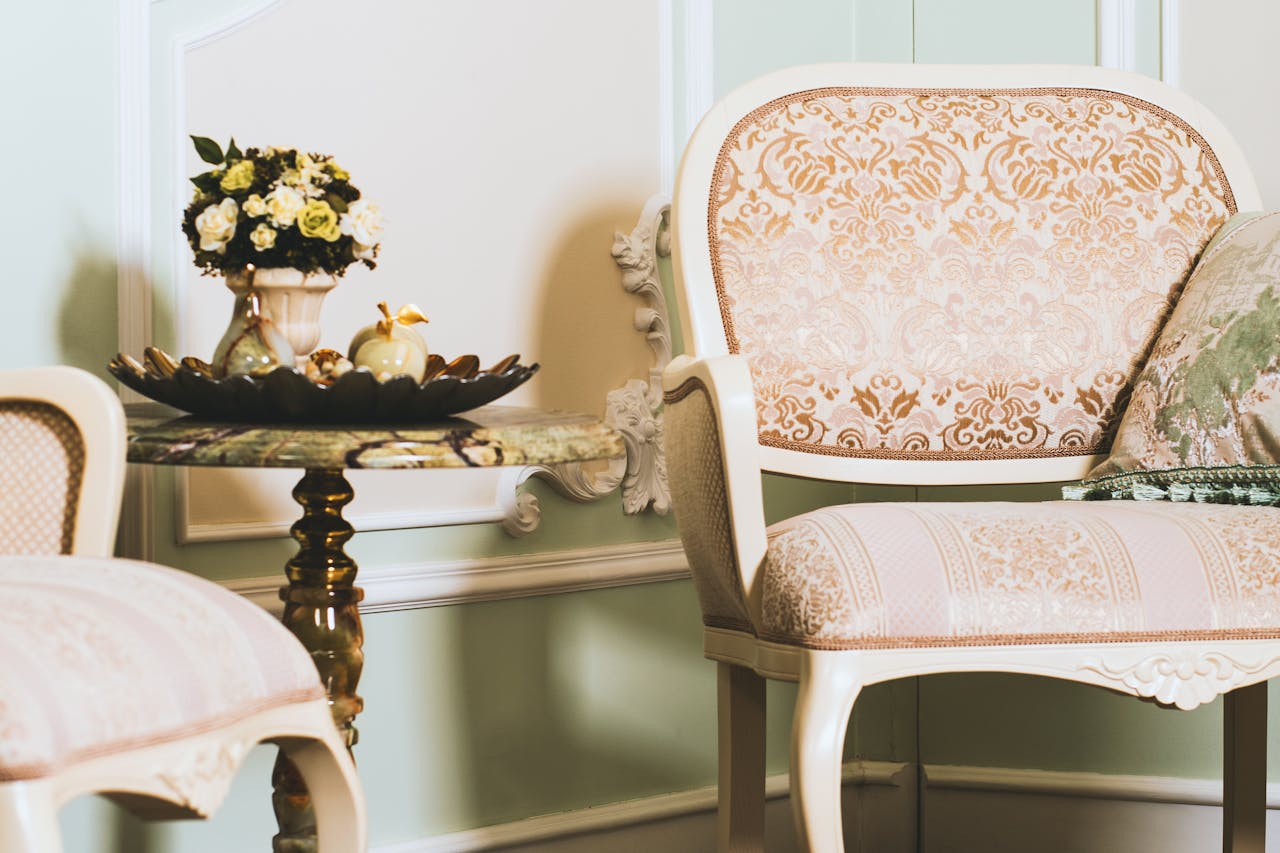 creative-02 A beautifully styled vintage interior featuring ornate chairs, a marble table, and elegant decor.